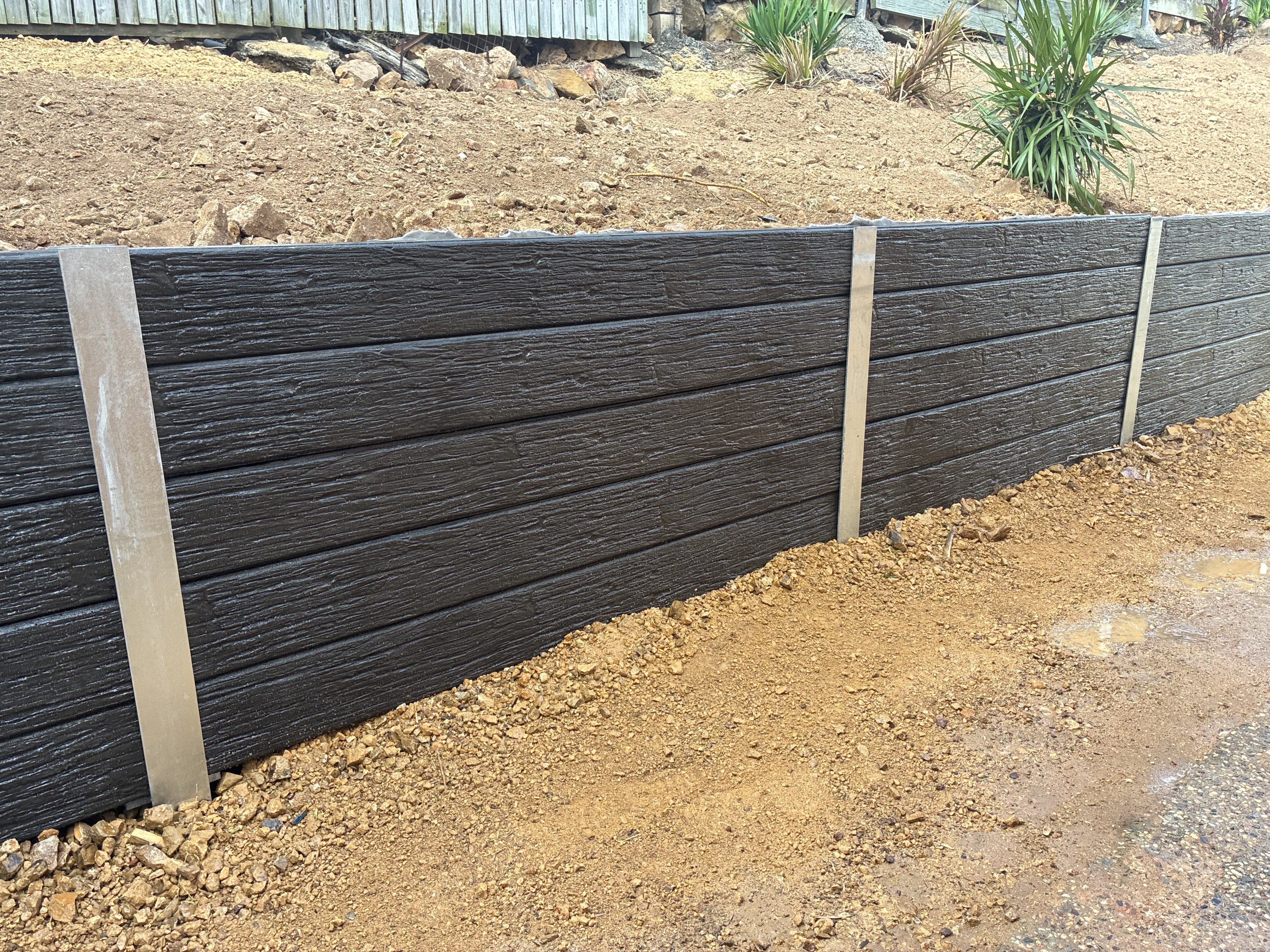 Timber sleeper retaining wall under construction in Rockhampton